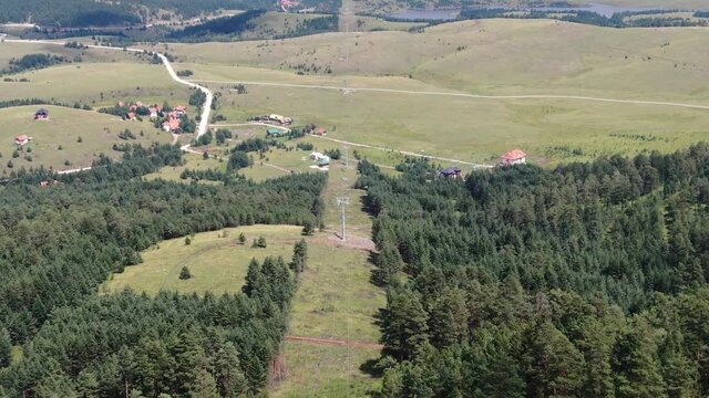 Zlatibor, Serbia. Aerial View of Gondola Ski Lift Route From Tornik Summit Above Green Fields of Mountain, Drone Shot