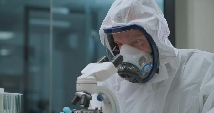 scientific laboratory of development of bacteriological and biological weapon, technician is dressed protective gown