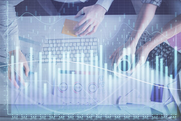 Double exposure of man and woman working together and financial chart hologram drawing. market analysis concept. Computer background. Top View.