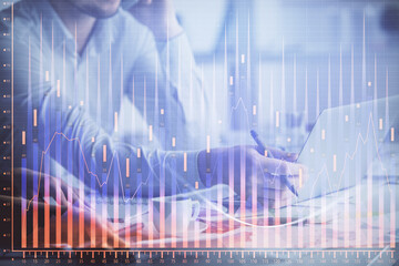 Double exposure of man and woman working together and financial graph hologram. Business concept. Computer background.