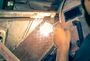 Welding Man Welding Car Mudguard or Construction in Garage by Electrode Arc Welding Technique in...