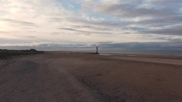 Slow Aerial Fly and Pass of Abandoned Lighthouse on a North Wales Beach