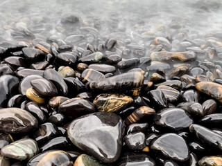 Beautiful multicoloured stones at Ko Hin Ngam island, Tarutao National Park in the Andaman Sea, Satun, Thailand The technique used - Long Exposure.