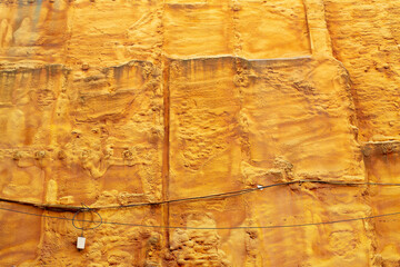 View of a wall on a construction site sprayed with yellow insulation