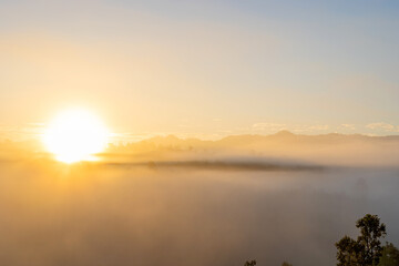 White puffy like cloud stretching to foggy horizon in the bright morning. View at sunrise with...