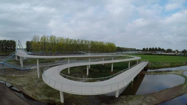 fly over dutch landscape with architectonic bike bridge