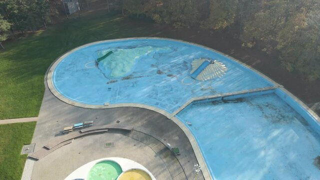 Low aerial of deserted outdoor swimming pool