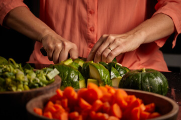 Closeup shot of a woman chopping cucumber