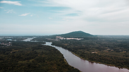 Panorama view of the meandering river and the mountain in countryside. river curve along forest.