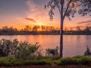 Fototapeta na wymiar Beautiful Riverside Sunset with Cloud Reflections