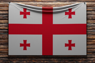 3D illustration of the national   fabric flag of Georgia  nailed on a wooden wall .Country symbol.