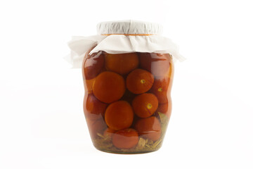 Glass jar with pickled tomatoes on a white background.