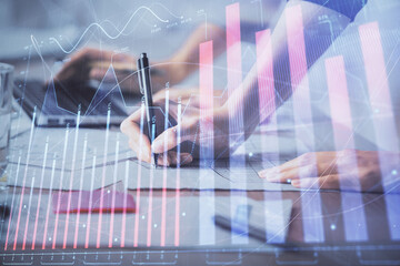 Multi exposure of woman hands typing on computer and financial chart hologram drawing. Stock market...