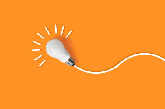 idea light bulb on orange background. creativity inspiration ,planning ideas concept