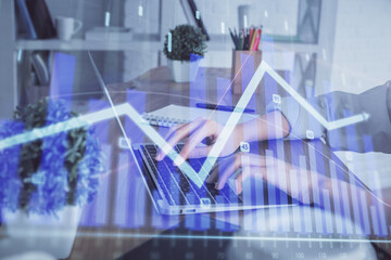 Double exposure of woman hands typing on computer and forex chart hologram drawing. Stock market...