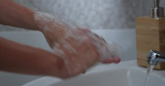 woman cleaning hands using soap to prevent virus spread