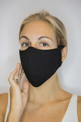 Close capture of blond girl wearing handmade linen face mask