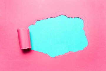 Diagonally torn pink paper with empty space for text of cyan background.