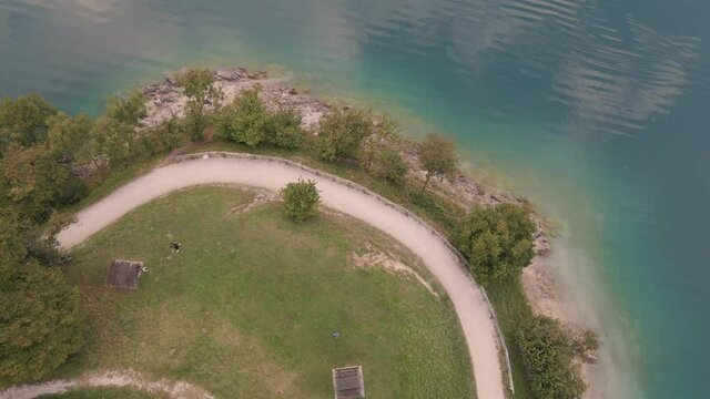 Masterpiece aerial shot of a unique and irresistible lake ledro with luxuriant environment