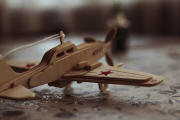 wooden toy airplane on a table with a shallow depth of field