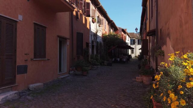 Narrow pedonal street in medieval village of Borghetto di Ostia in the outskirts of Rome. Dolly motion.