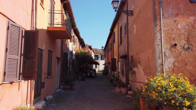 Narrow pedonal street in medieval village of Borghetto di Ostia in the outskirts of Rome. Truck motion.