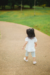 Toddler walking in the park on daylight