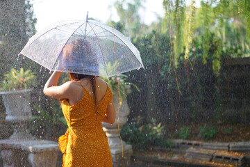 Beautiful womanstanding holding an umbrella in the rain