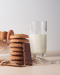 Oatmeal cookies with chocolate chunks and milk in a glass. Delicious healthy breakfast.