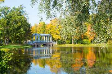 Fototapeta premium reflection of autumn forest in blue lake in the park 