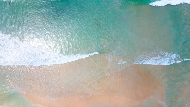 Aerial view of drone. Scene of top view beach and seawater on sandy beach in summer. Nature and travel concept.