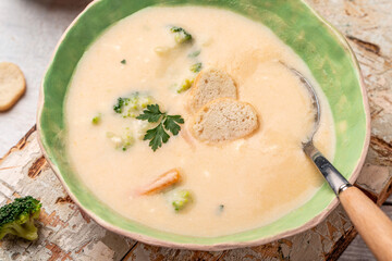 Creamy cauliflower soup with croutons in bowl on a light background. Top view