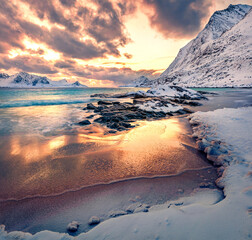 Colorful winter sunset on Lofoten Islands, Norway, Europe. Breathtaking morning scene of popular tourist destination - Skagsanden beach, Flakstadoya island. Untouched Winter Landscape.