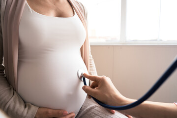 Happy pregnant woman visit gynecologist doctor at hospital or medical clinic for pregnancy...