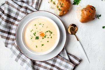 Homemade potato cheese cream soup on a light background, top view