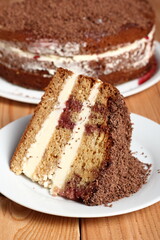 Fototapeta na wymiar Layer Cake with cream with grated chocolate topping