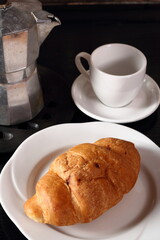 Croissant, coffee cup and moka pot