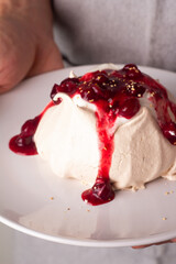 meringue with cream and red berries close-up

