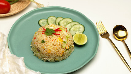 Homemade Thai fried rice on dinning table with cutlery and napkin