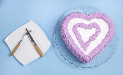 Utensil and sweet cake on blue background.