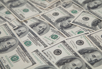 A pile of one hundred US banknotes. Dollar background image.