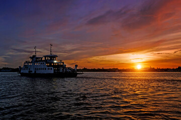 Fototapeta premium Ferry across the river at dawn