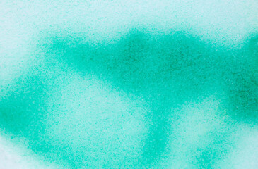 Green paint on the snow in winter.