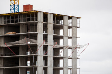 multi-storey building under construction against a gray sky
