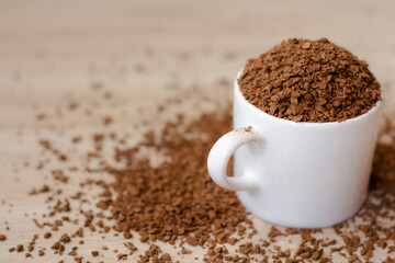 Instant soluble coffee In a white ceramic mug on wooden floor