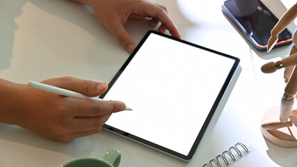 Male hand using digital  tablet on white worktable, include clipping path