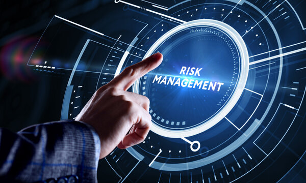 Business, Technology, Internet and network concept. Young businessman shows the word on the virtual display of the future: Risk management