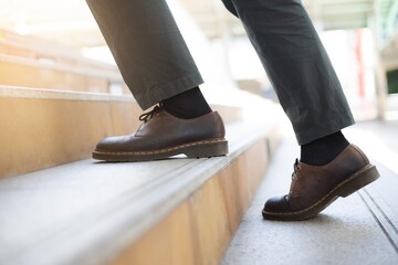 Close up  of businessman.In the morning of the capital Walk up the stairs at rush hour,To work in...