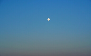 Nature scene of the moon in day time isolated with blue sky background - minimal abstract patterns          