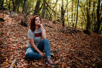 traveler hipster woman standing alone in autumn woods .